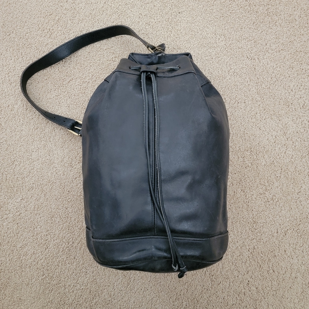 COACH black leather single strap backpack.